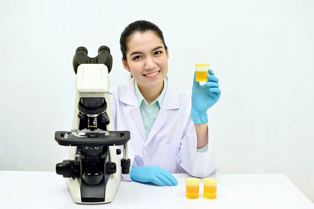 Medical technologist show urine sample for analysis