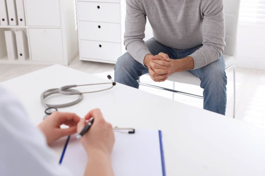 Man having appointment with STD specialist in clinic