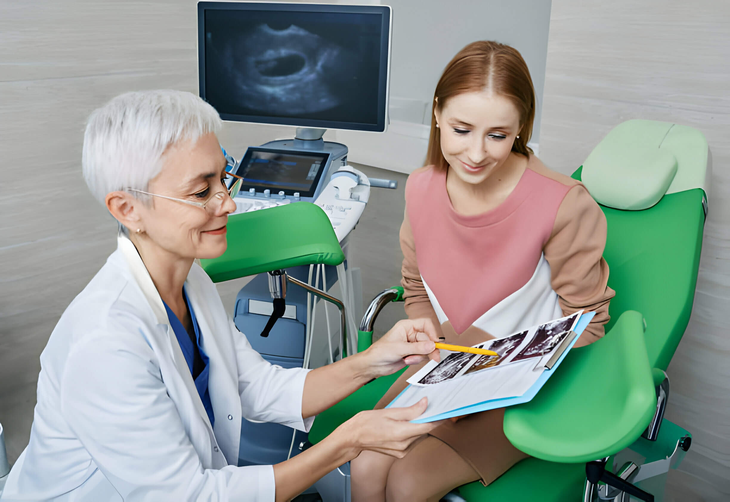 Woman sitting on gynecological chair while consultation with her gynecologist in gynecological office of medical clinic