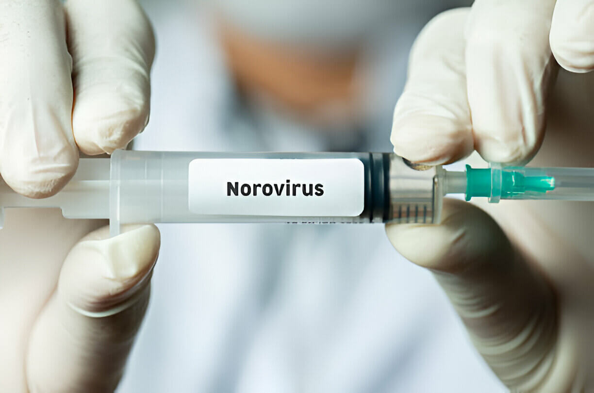 Doctor holding Norovirus vaccine.