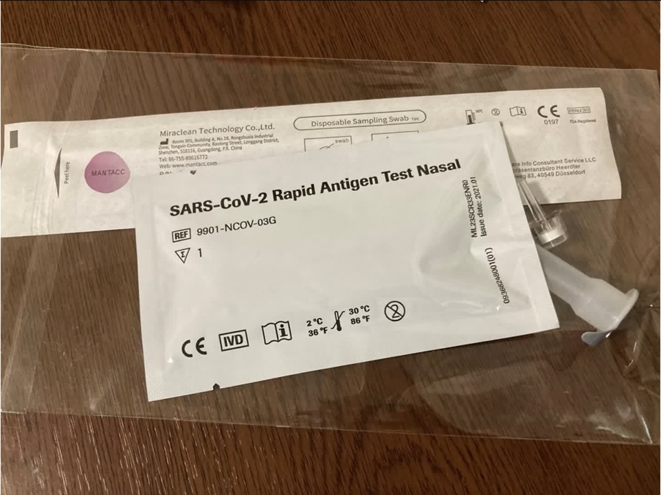 Mantacc's flocked nasopharyngeal swab and a self-testing kit on the desk 