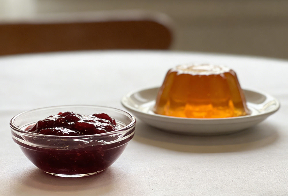 a bowl of jam and a portion of jelly