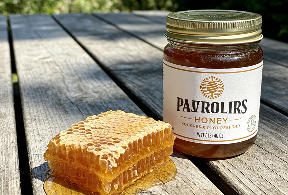 raw honey and stored honey on a wooden table