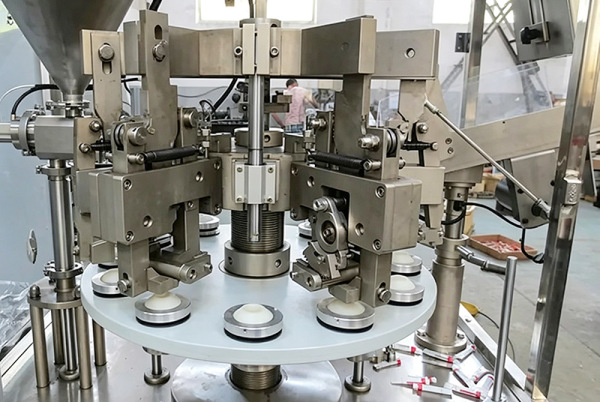 Tube filling machine mechanism